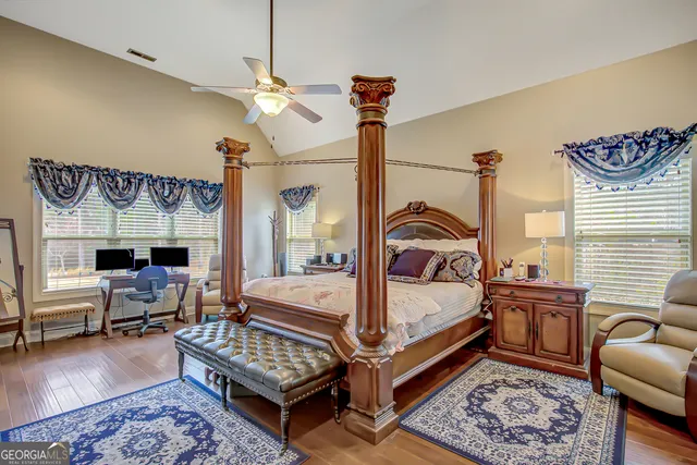 a bedroom with a bed couch and window