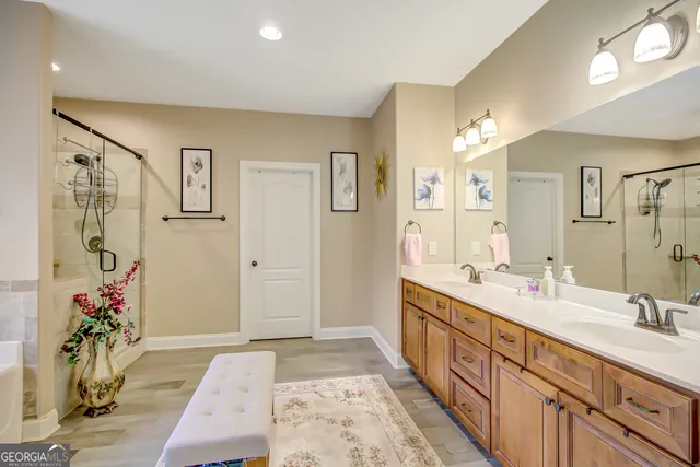 a bathroom with a sink vanity granite tub and shower
