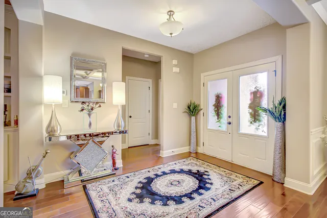 a kitchen with stainless steel appliances kitchen island granite countertop a dining table chairs and sink