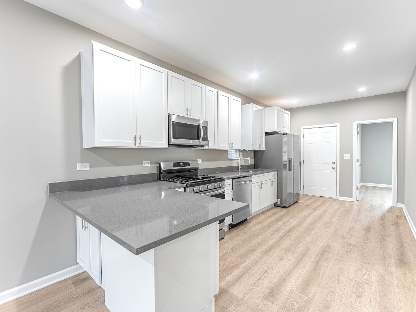 2733 West 38th Street Chicago, IL 60632 - Photo 9 of 30 a kitchen with kitchen island granite countertop a stove sink microwave and refrigerator