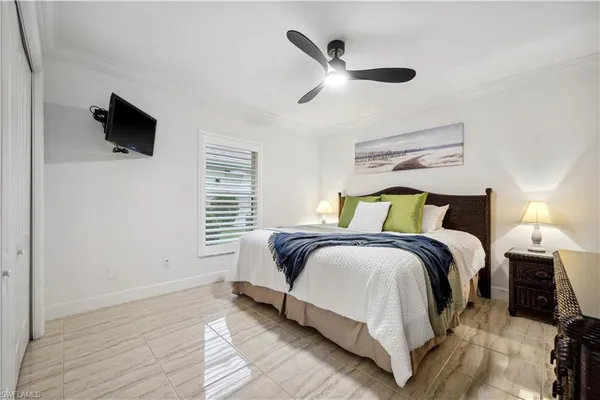 a bedroom with a bed and a flat screen tv