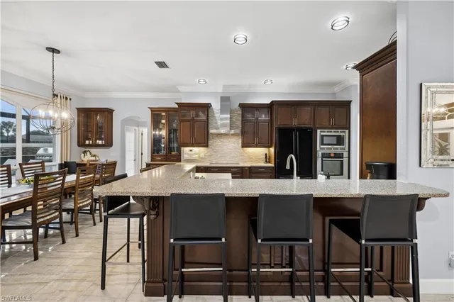 a kitchen with cabinets table and chairs