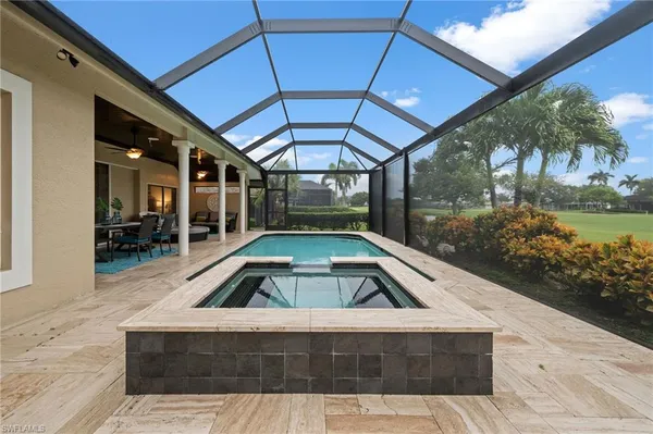 a view of swimming pool with seating area