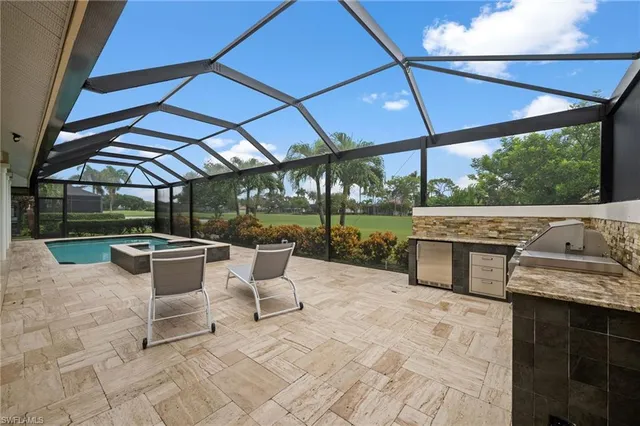 a view of a patio with a table chairs and a backyard