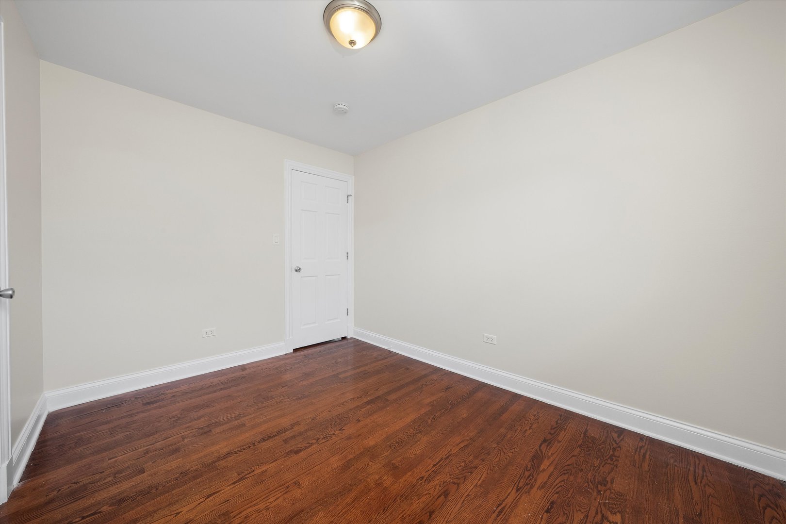 7918 74th Street Bridgeview, IL 60455 - Photo 18 of 26 a view of an empty room with wooden floor