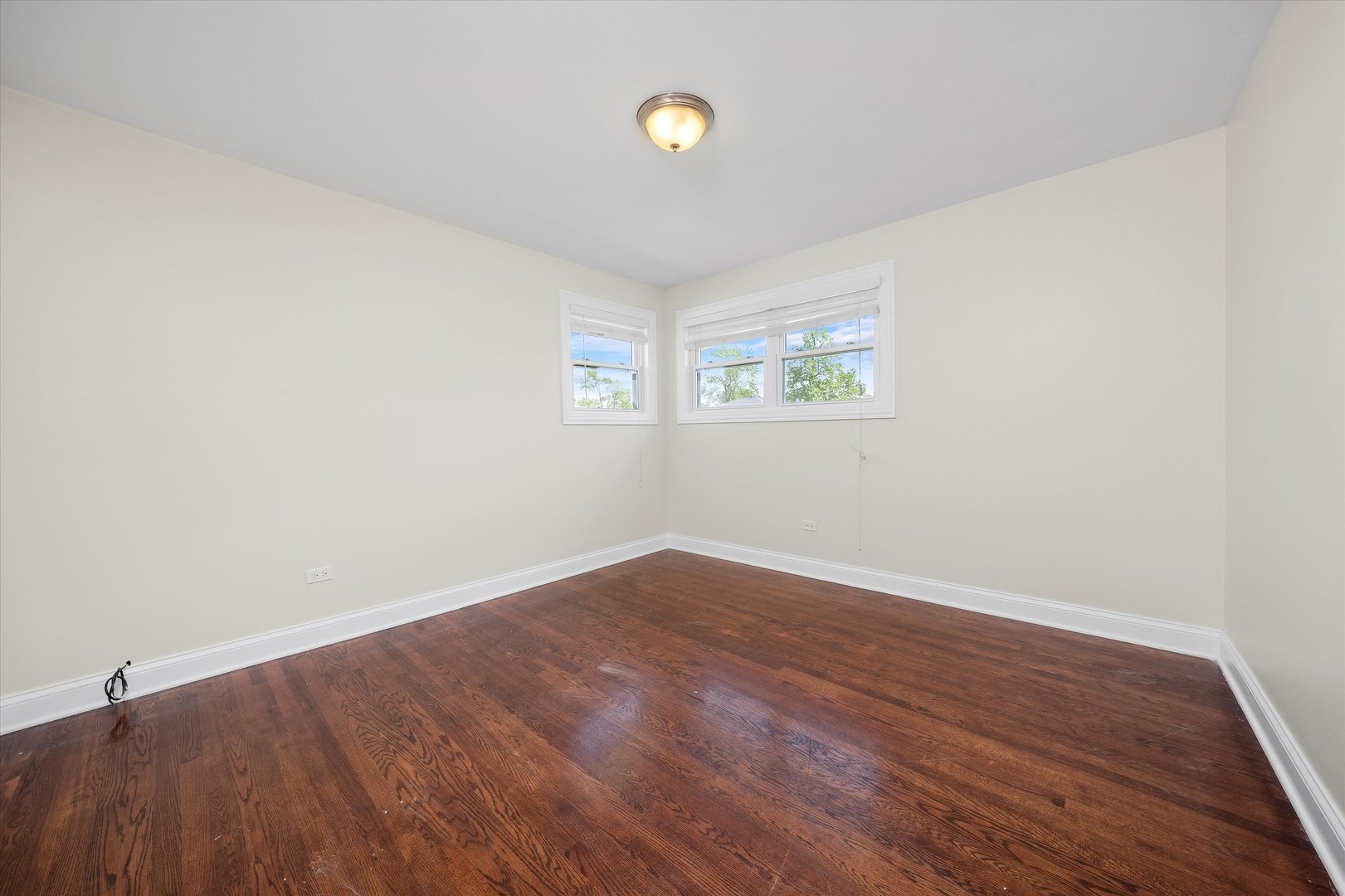 7918 74th Street Bridgeview, IL 60455 - Photo 19 of 26 wooden floor in an empty room with a window
