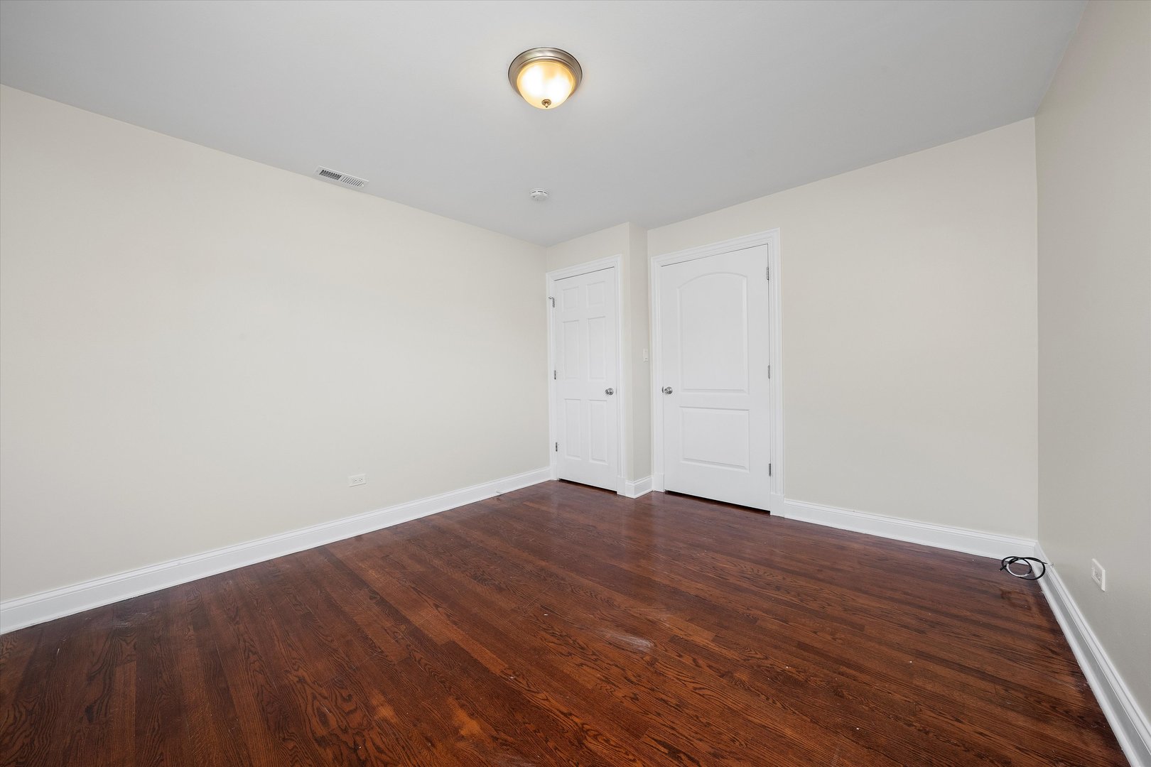 7918 74th Street Bridgeview, IL 60455 - Photo 20 of 26 an empty room with wooden floor and a window