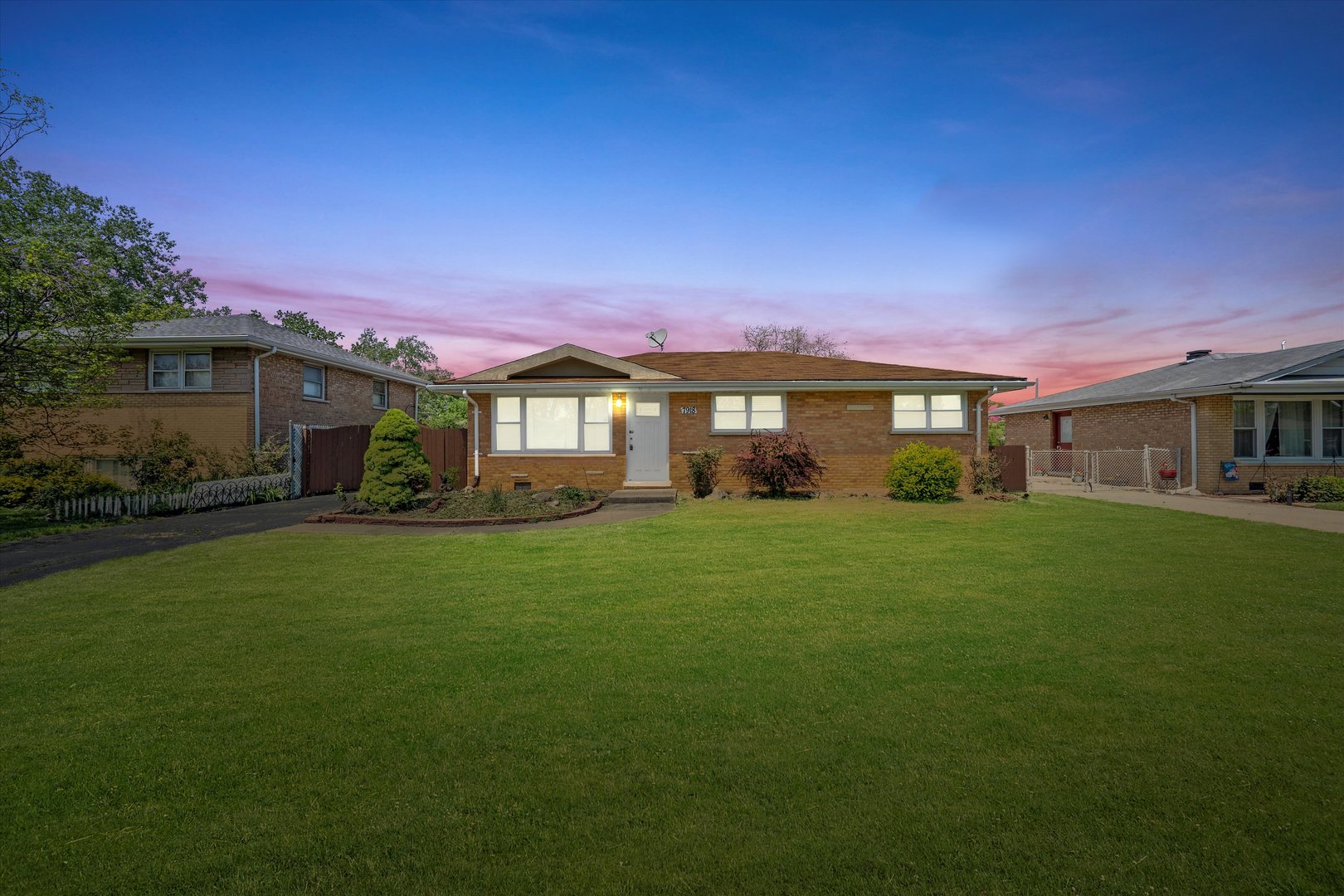 7918 74th Street Bridgeview, IL 60455 - Photo 2 of 26 a front view of a house with a garden
