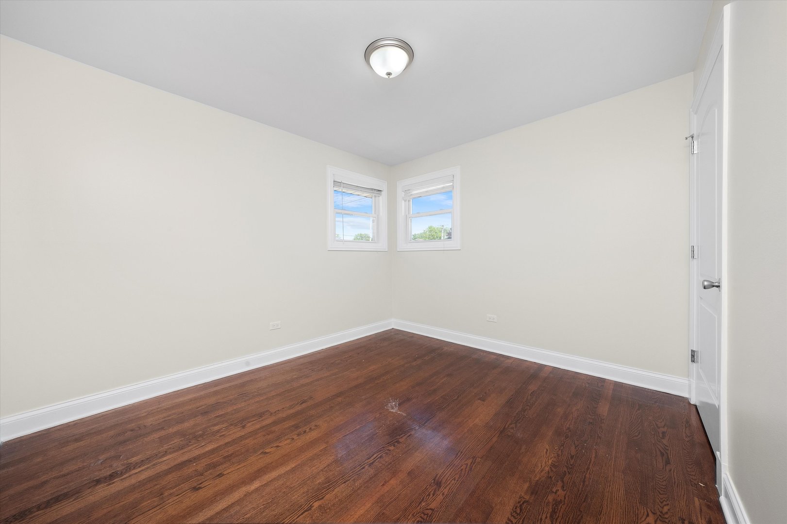 7918 74th Street Bridgeview, IL 60455 - Photo 21 of 26 an empty room with wooden floor and windows