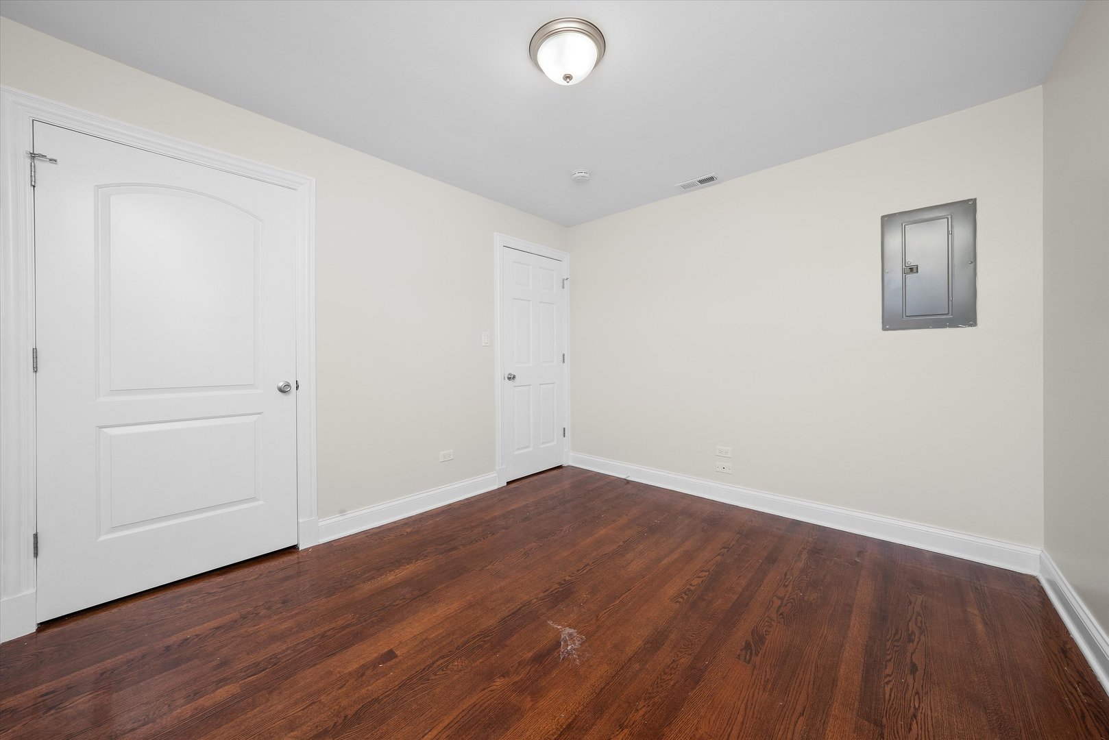 7918 74th Street Bridgeview, IL 60455 - Photo 22 of 26 an empty room with wooden floor and windows