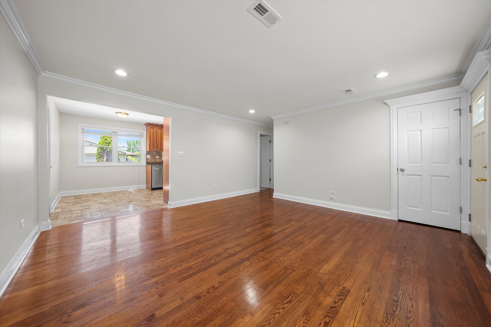 7918 74th Street Bridgeview, IL 60455 - Photo 6 of 26 a view of empty room with wooden floor and window
