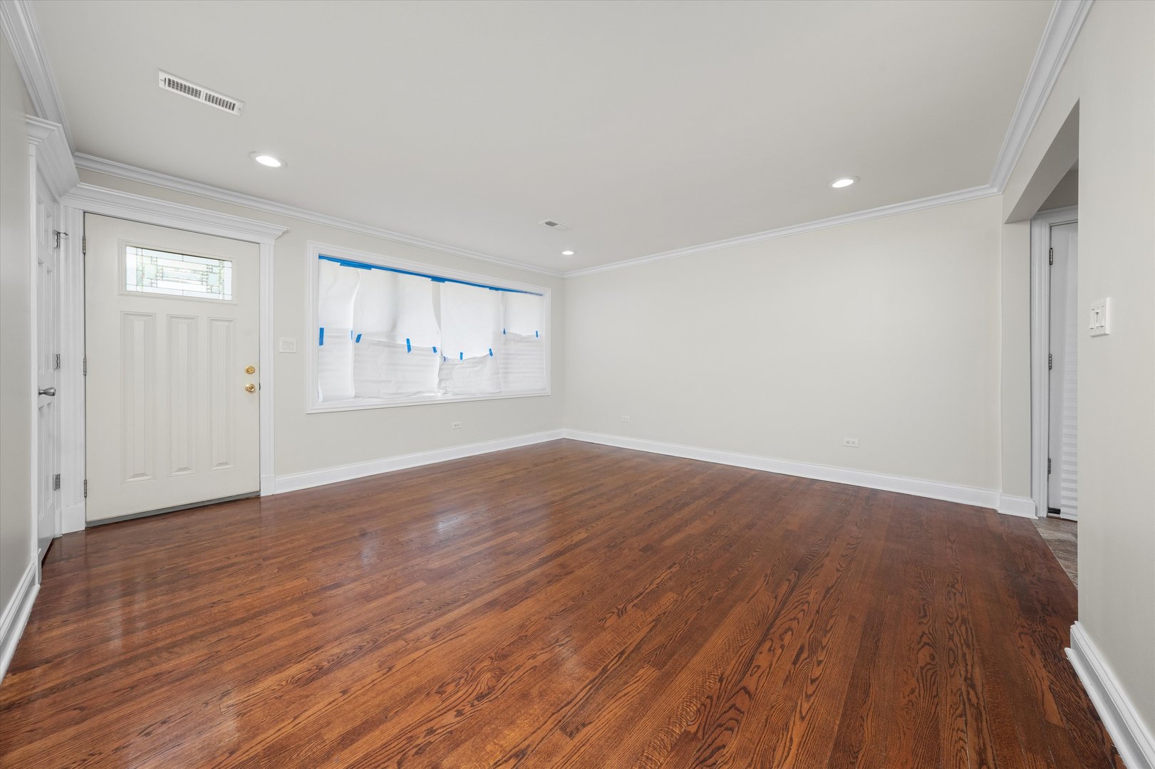 7918 74th Street Bridgeview, IL 60455 - Photo 8 of 26 a view of empty room with wooden floor and fan
