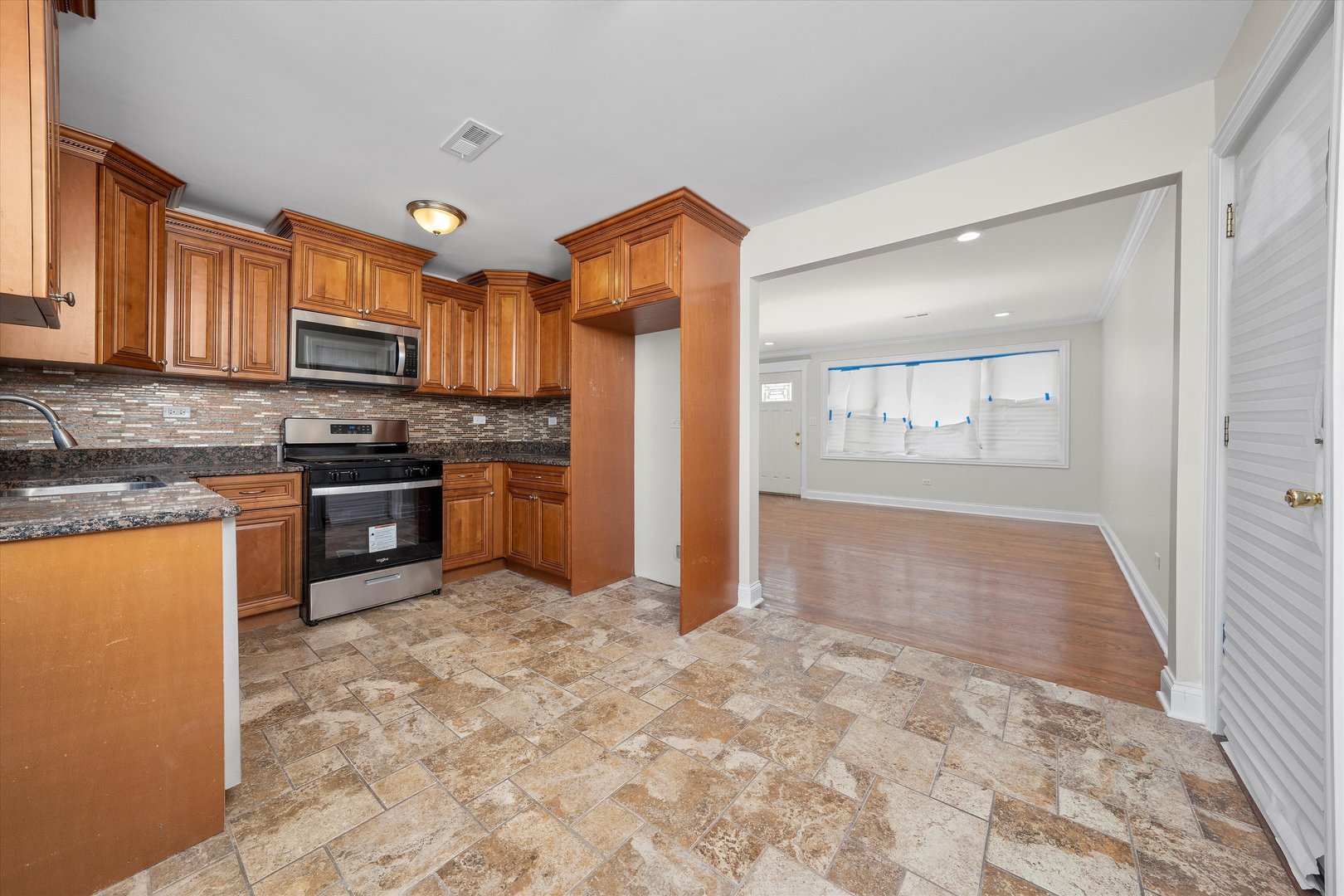 7918 74th Street Bridgeview, IL 60455 - Photo 10 of 26 a kitchen with stainless steel appliances granite countertop a refrigerator stove top oven and sink