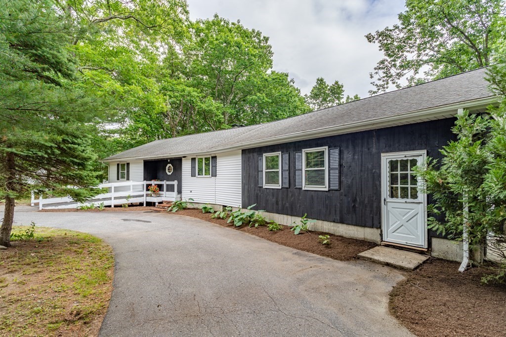 85 Kaleva Road Lancaster, MA 01523 - Photo 14 of 15 a view of a patio with table and chairs under an umbrella