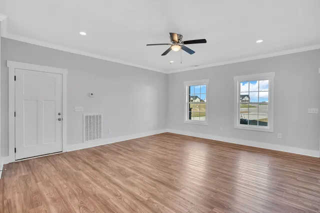 a bathroom with a granite countertop sink vanity mirror and toilet
