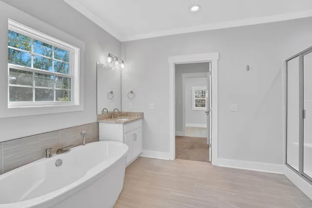 an empty room with windows and ceiling fan