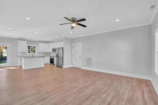 a kitchen with granite countertop cabinets stove and sink