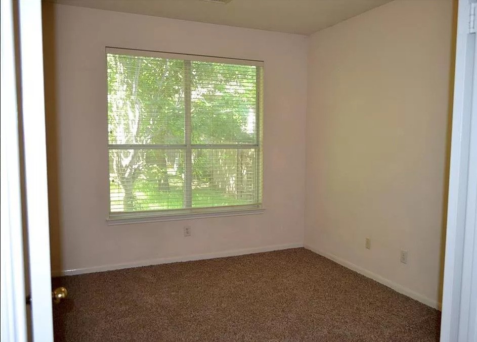 2210 Equestrian Trail Austin, TX 78727 - Photo 4 of 16 an empty room with a window