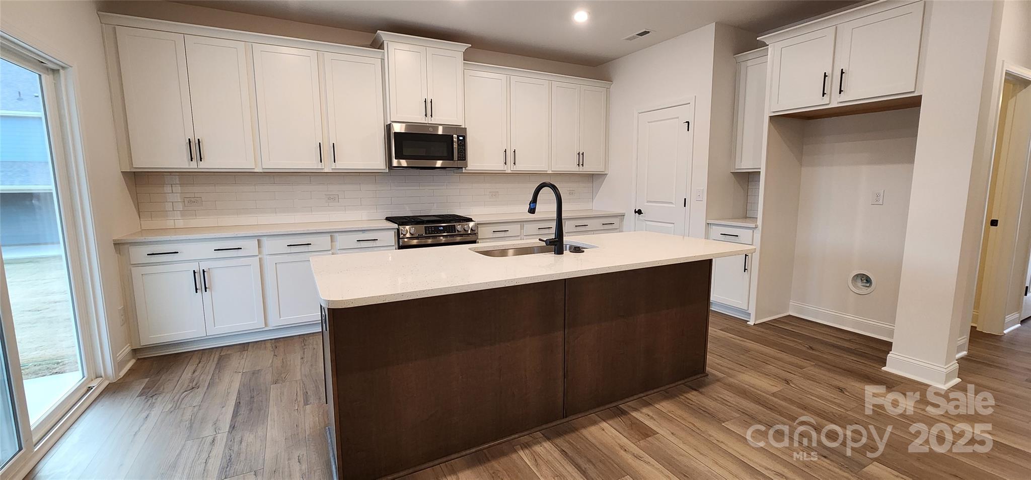 734 Sirius Lane York, SC 29745 - Photo 4 of 23 a kitchen with a sink cabinets and wooden floor