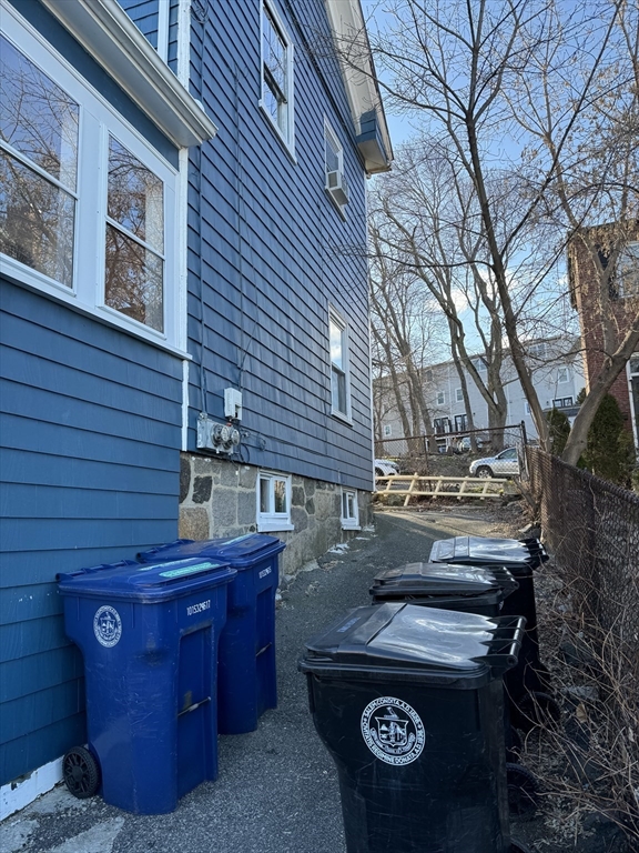 6 Proctor Street Salem, MA 01970 - Photo 21 of 26 a view of a backyard with chairs and a fire pit