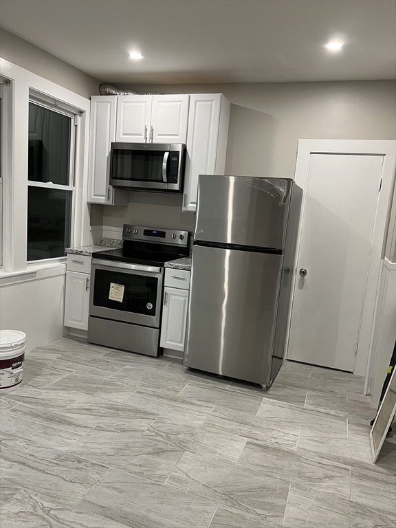 6 Proctor Street Salem, MA 01970 - Photo 3 of 26 a kitchen with a refrigerator stove and microwave