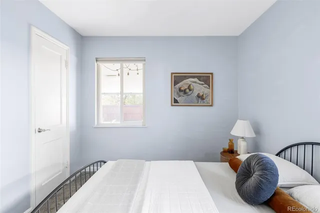 a bedroom with a bed and a lamp