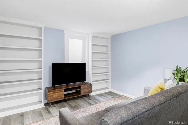 a living room with a flat screen tv and view of couch
