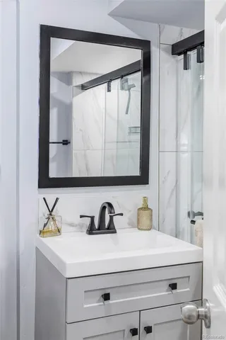 a bathroom with a sink and a mirror