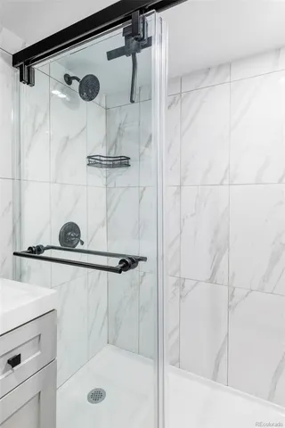 a bathroom with a shower and a sink