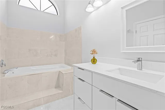 a bathroom with a sink and a bath tub