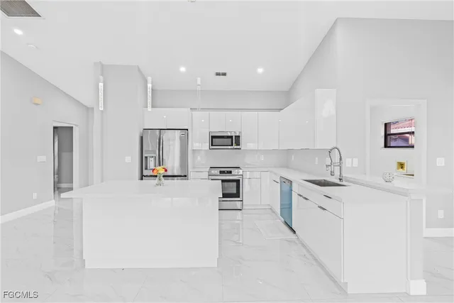 a large kitchen with stainless steel appliances lots of counter top space