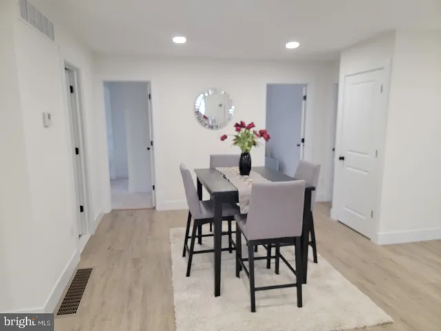 a dining room with furniture and wooden floor
