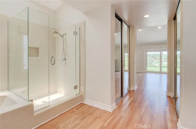a bathroom with a glass shower door and a bathtub
