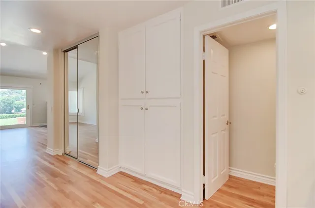 a view of a hallway with wooden floor