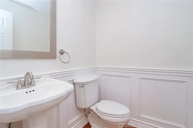 a bathroom with a sink mirror vanity and toilet