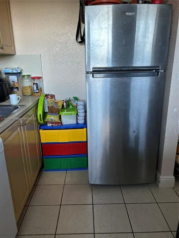 a kitchen with stainless steel appliances granite countertop a refrigerator and a stove