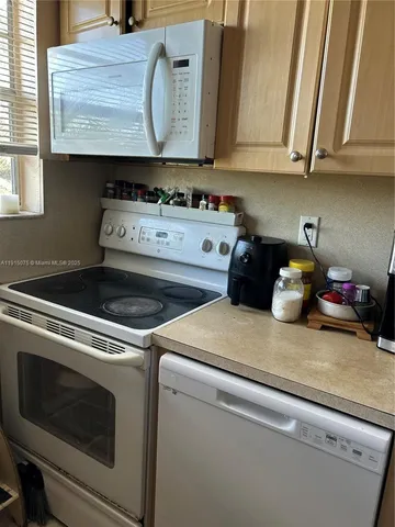 a kitchen with stove and cabinets