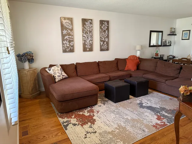 a living room with furniture and painting on the wall