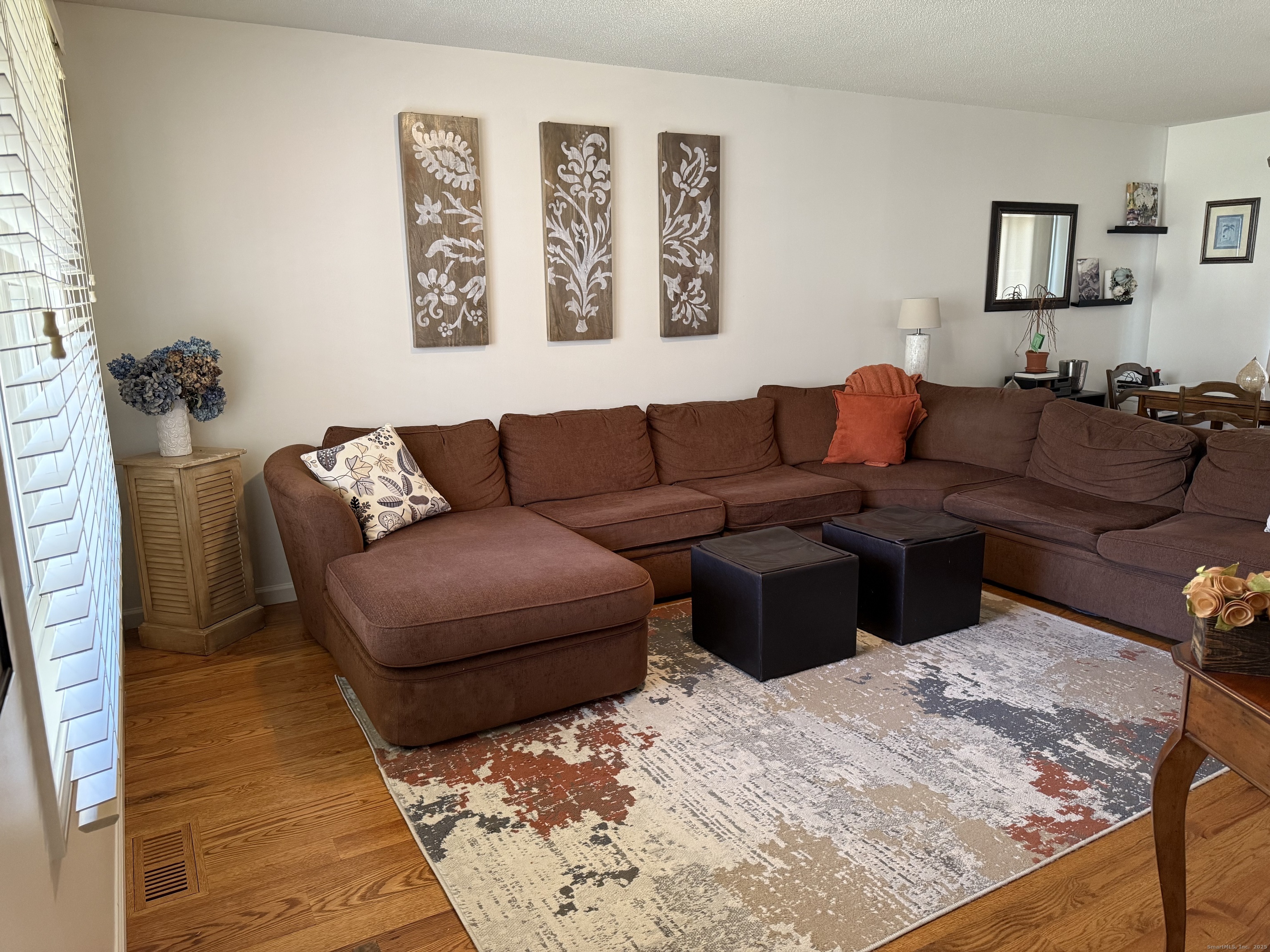 19 Wagon Trail Wolcott, CT 06716 - Photo 13 of 31 a living room with furniture and painting on the wall