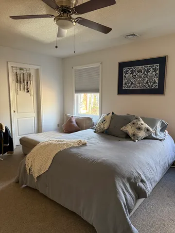 a bedroom with bed and window