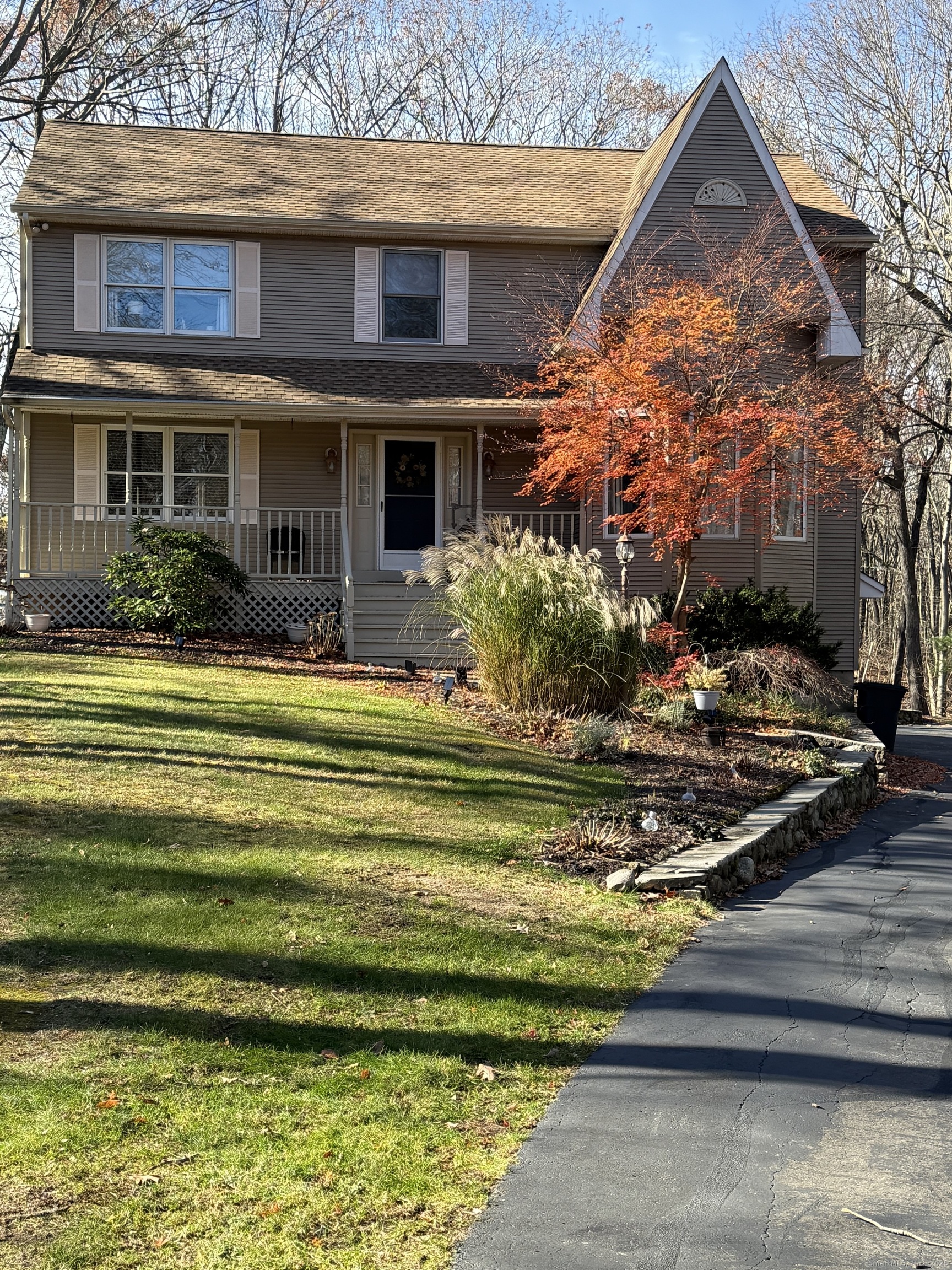 19 Wagon Trail Wolcott, CT 06716 - Photo 2 of 31 a front view of a house with a yard table and chairs