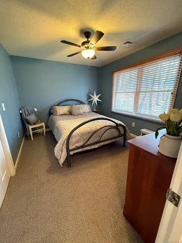 a bed room with a bed and a chair