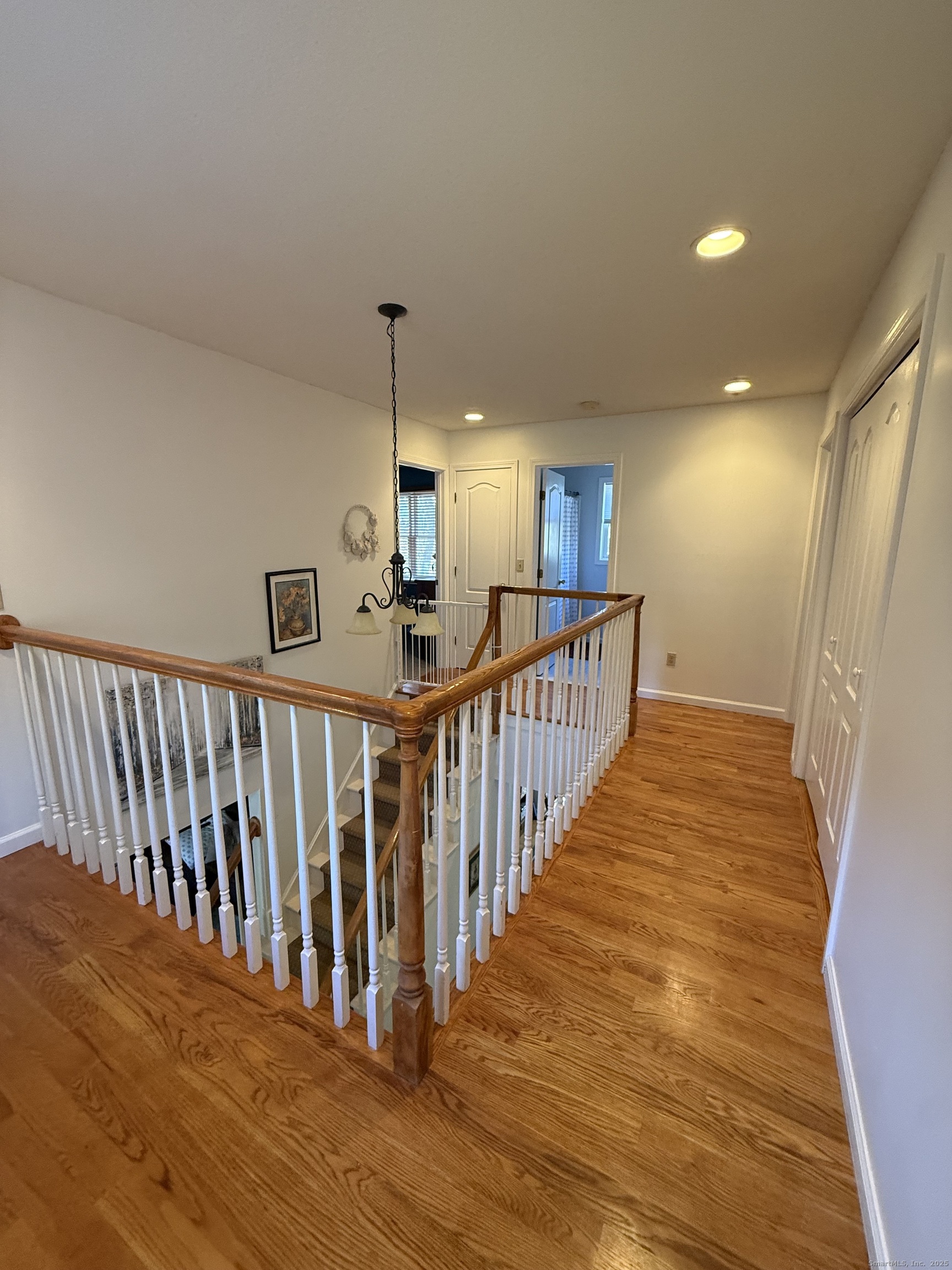 19 Wagon Trail Wolcott, CT 06716 - Photo 27 of 31 a view of a hallway with wooden floor and stairs