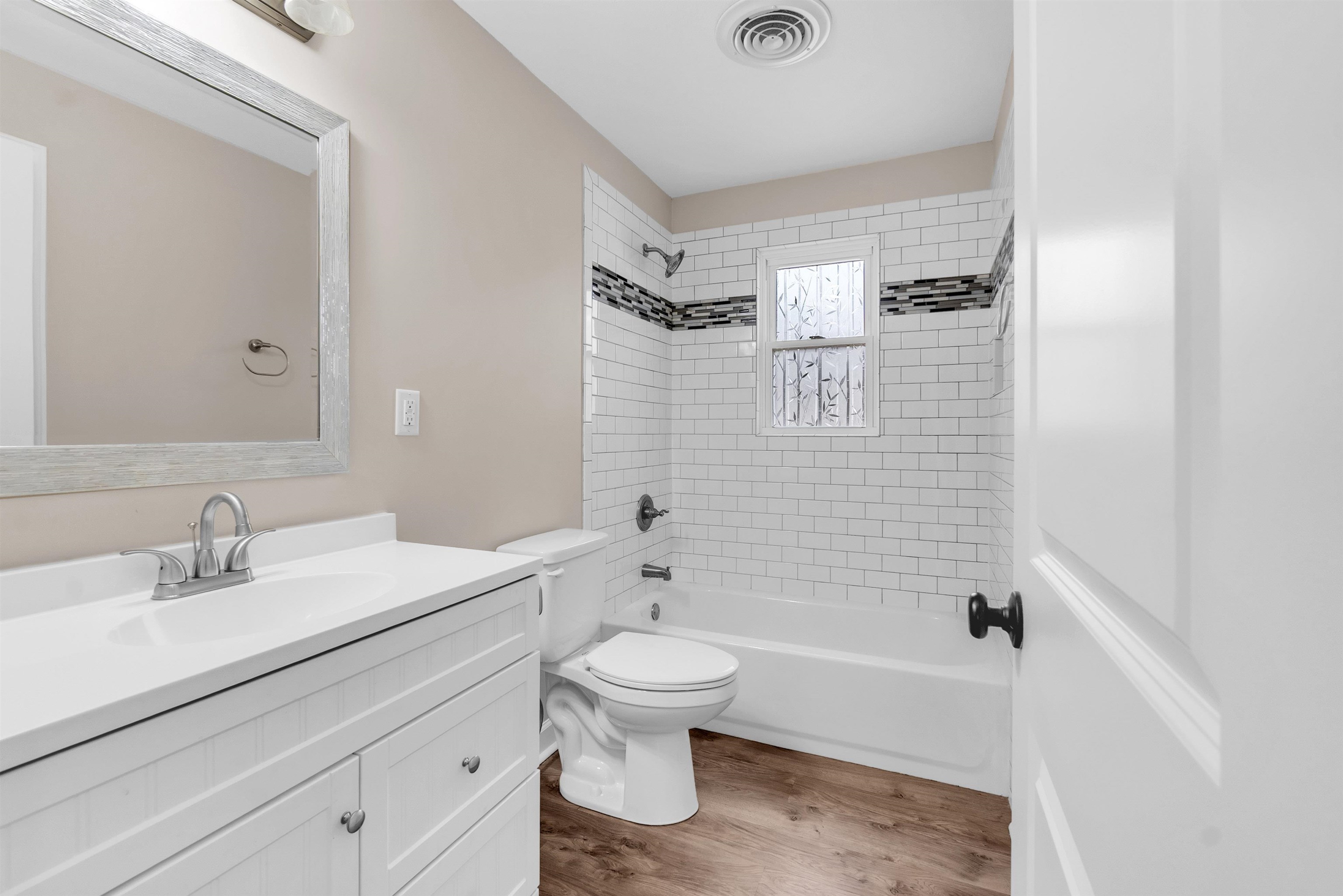 1371 Phillips Road Memphis, TN 38134 - Photo 14 of 35 Bathroom featuring shower combination, vanity, and dark wood-type flooring