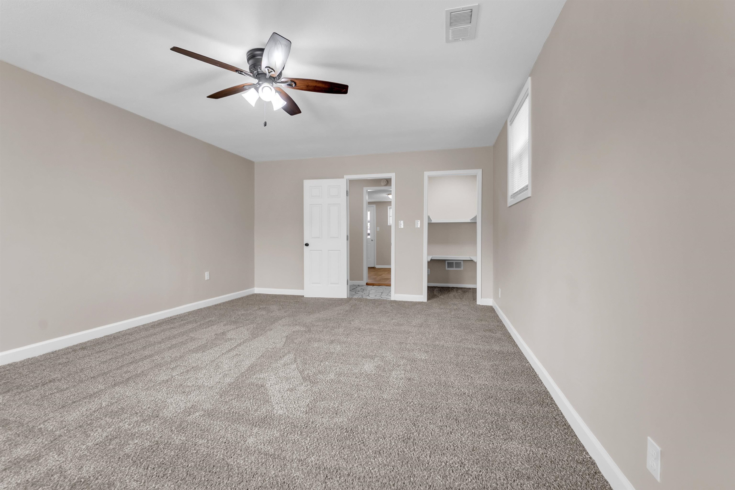 1371 Phillips Road Memphis, TN 38134 - Photo 24 of 35 Unfurnished bedroom featuring carpet flooring, a spacious closet, and a ceiling fan