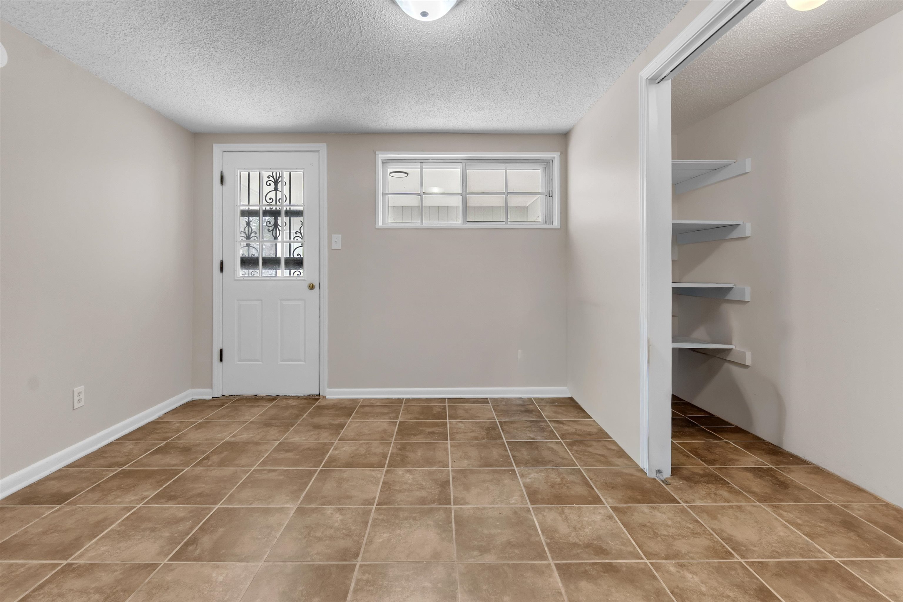1371 Phillips Road Memphis, TN 38134 - Photo 29 of 35 Doorway featuring a textured ceiling and plenty of natural light