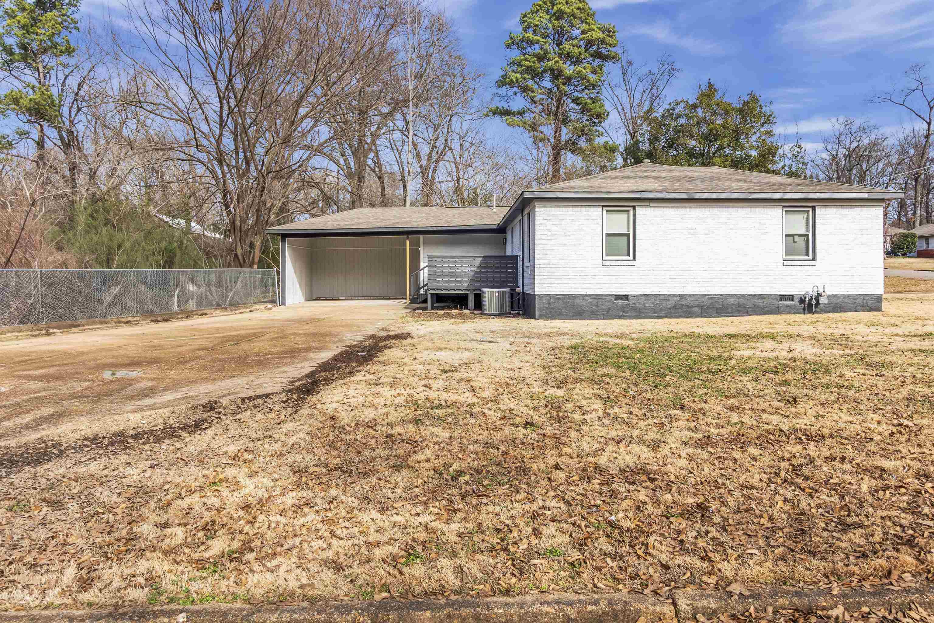 1371 Phillips Road Memphis, TN 38134 - Photo 31 of 35 View of property exterior featuring crawl space, a carport, driveway, and brick siding