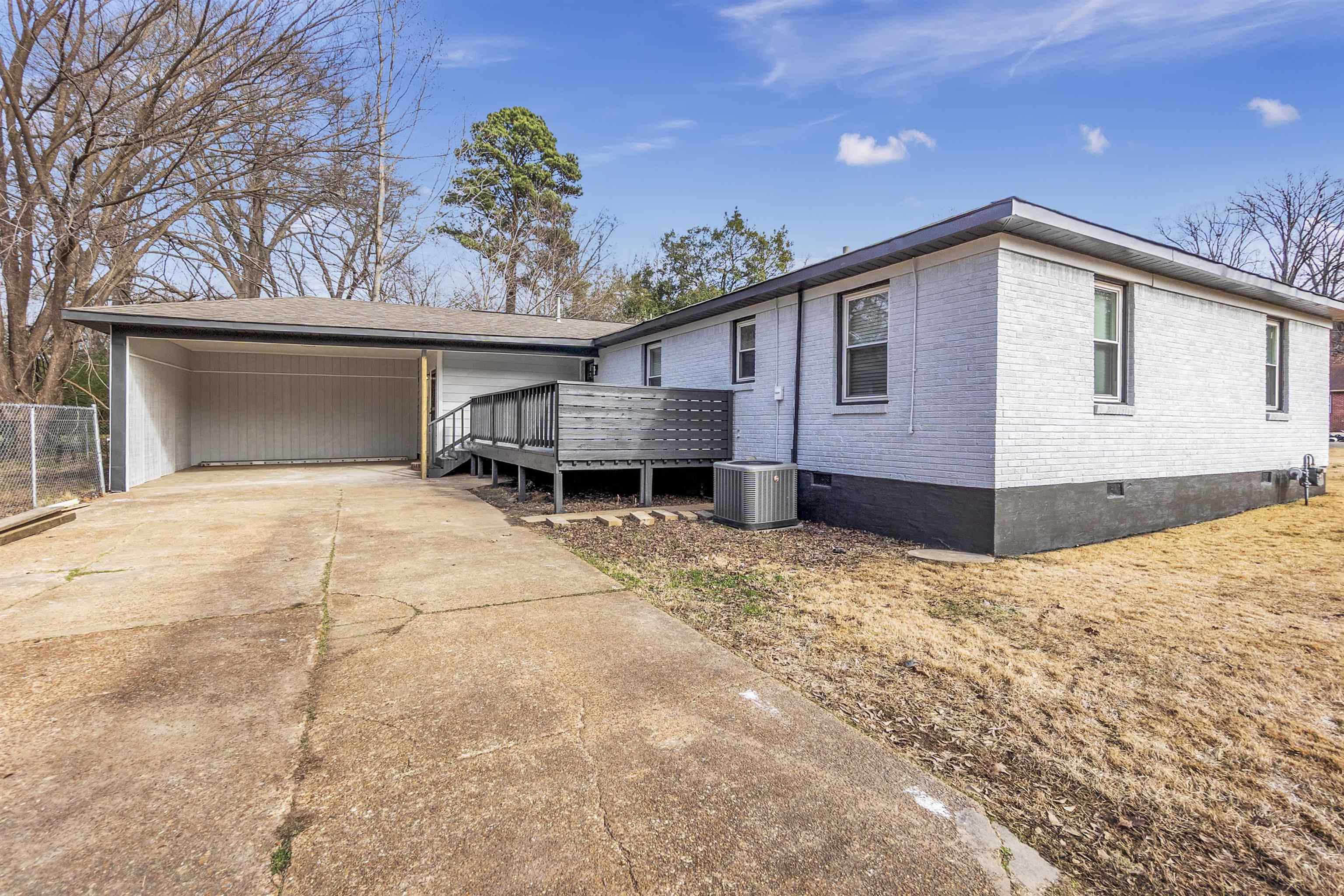 1371 Phillips Road Memphis, TN 38134 - Photo 5 of 35 View of front of home with crawl space, brick siding, a wooden deck, driveway, and an attached carport