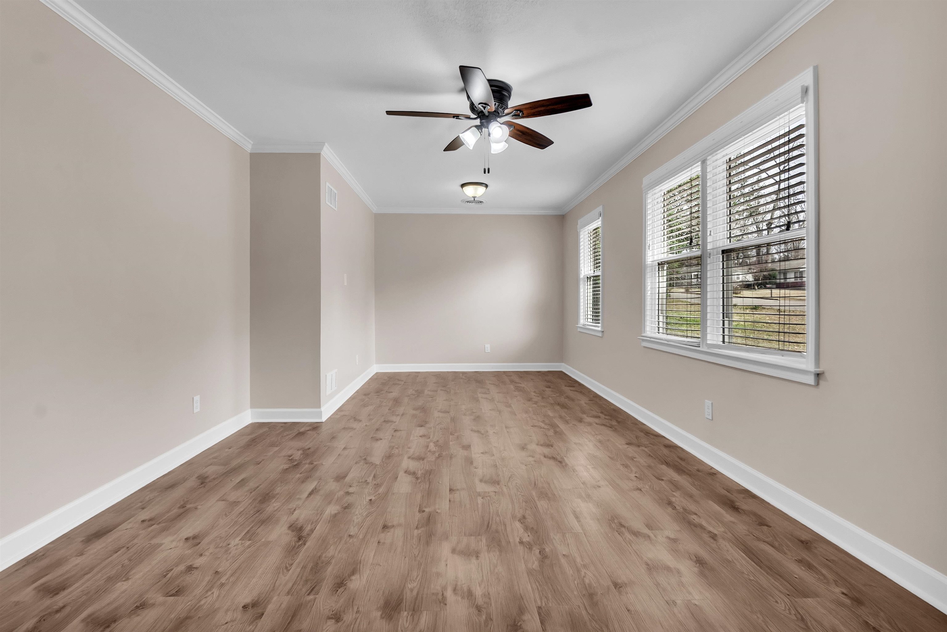 1371 Phillips Road Memphis, TN 38134 - Photo 6 of 35 Empty room with crown molding, light wood-style flooring, and ceiling fan