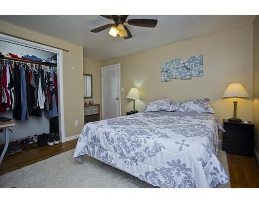 28 Barton Street Springfield, MA 01104 - Photo 11 of 26 a bedroom with a bed and a lamp
